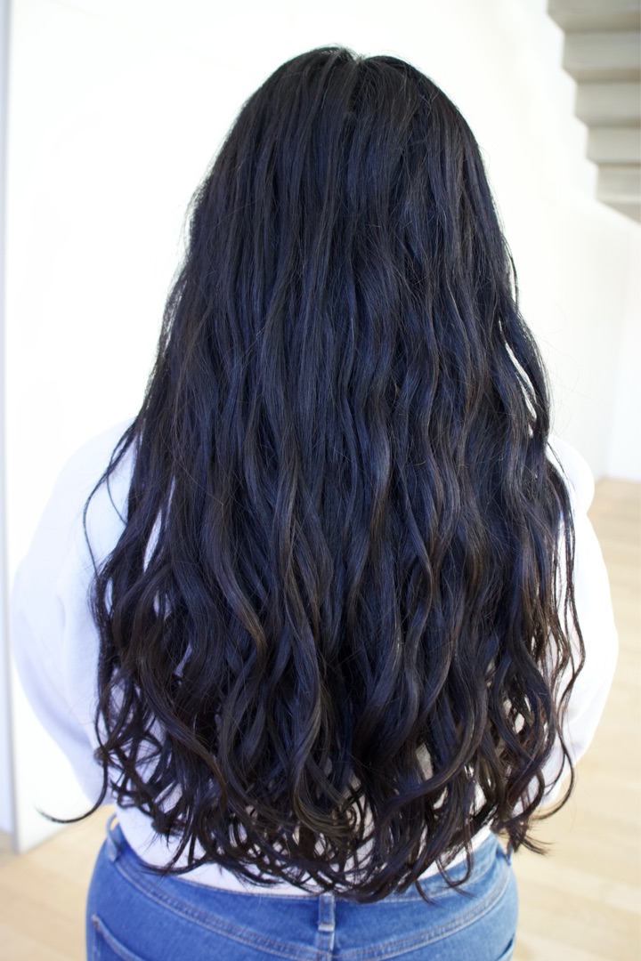 Long blue-black waves after a curl-by-curl cut