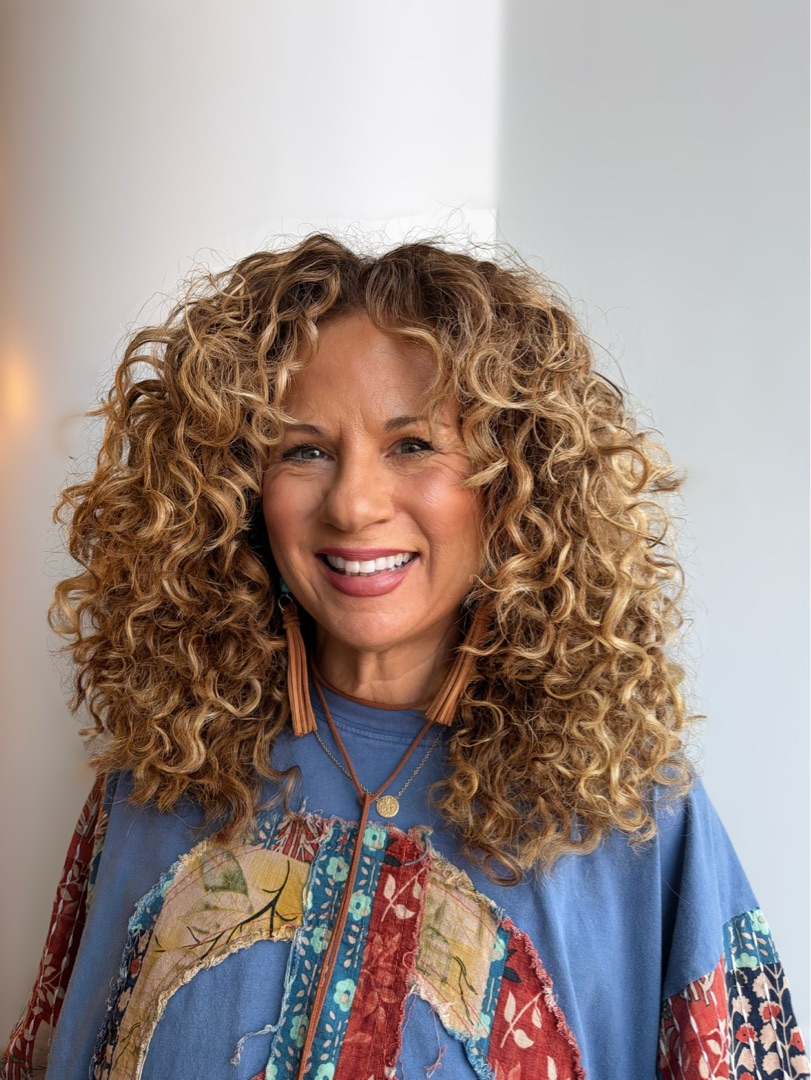 Honey-blonde curls with hand-painted highlights, finished look